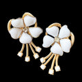 Vintage Schiaparelli white flower clip on earrings.