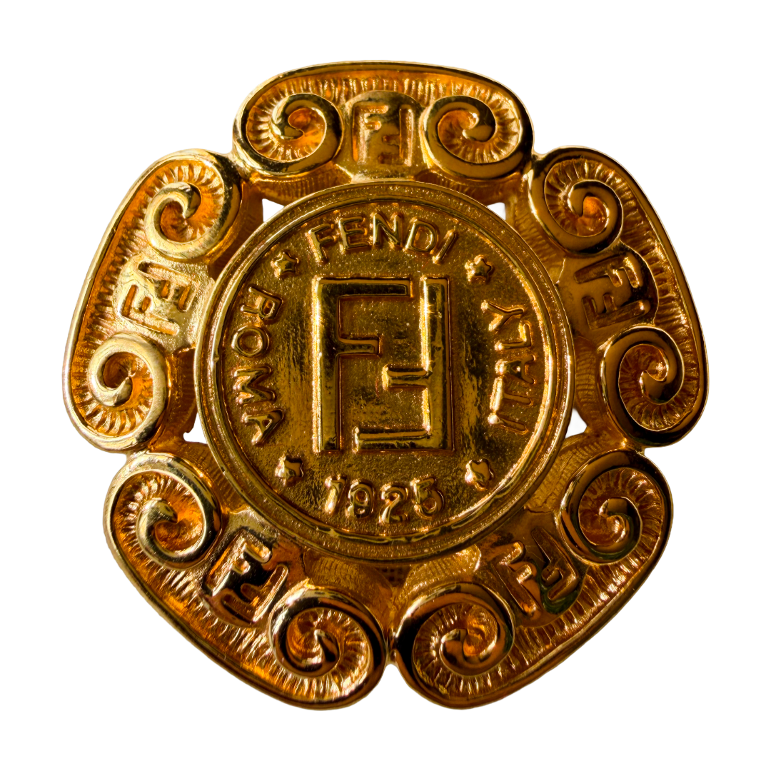 Gold emblem medallion brooch with intricate designs and vintage Fendi branding
