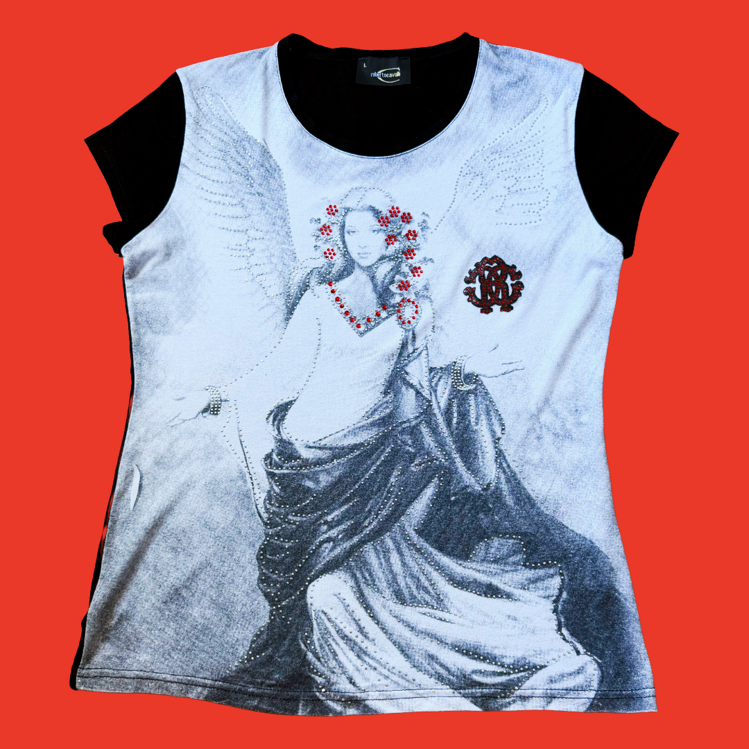 A women's short-sleeve t-shirt with a black crew neck and black cap sleeves, featuring a large graphic print of a winged angel in black and white with red floral accents by Roberto Cavalli.