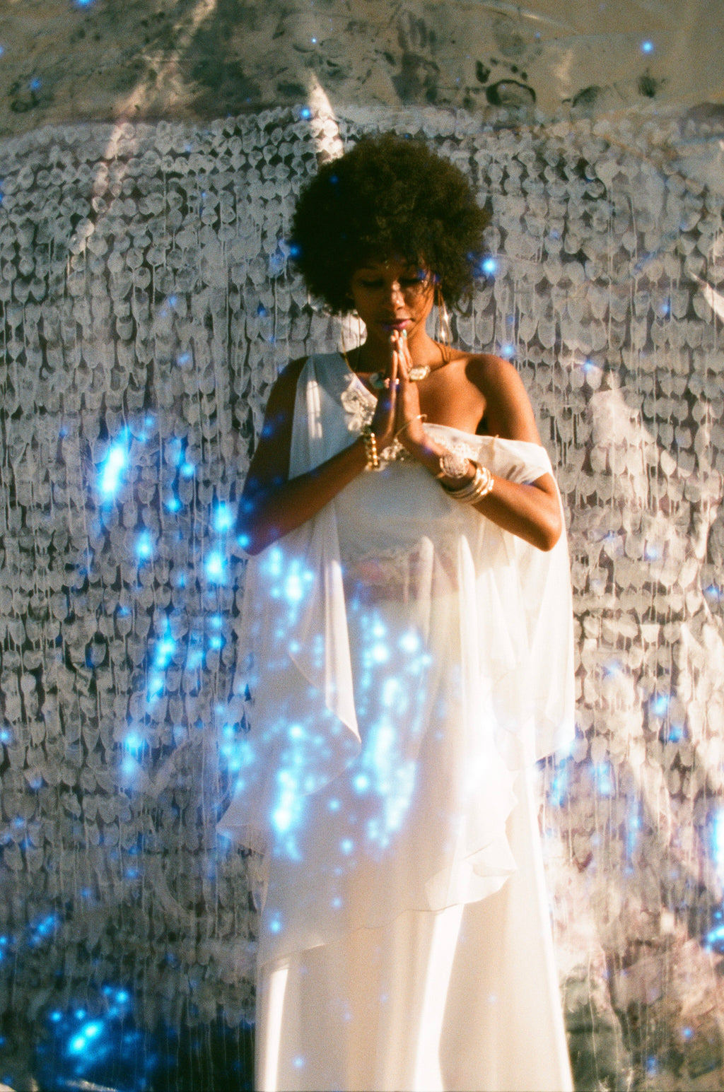 Lizzy Jeff models an ethereal white 1970s maxi dress with angel sleeves.  Find the best 70s vintage at Empress Vintage in San Francisco and Berkeley.