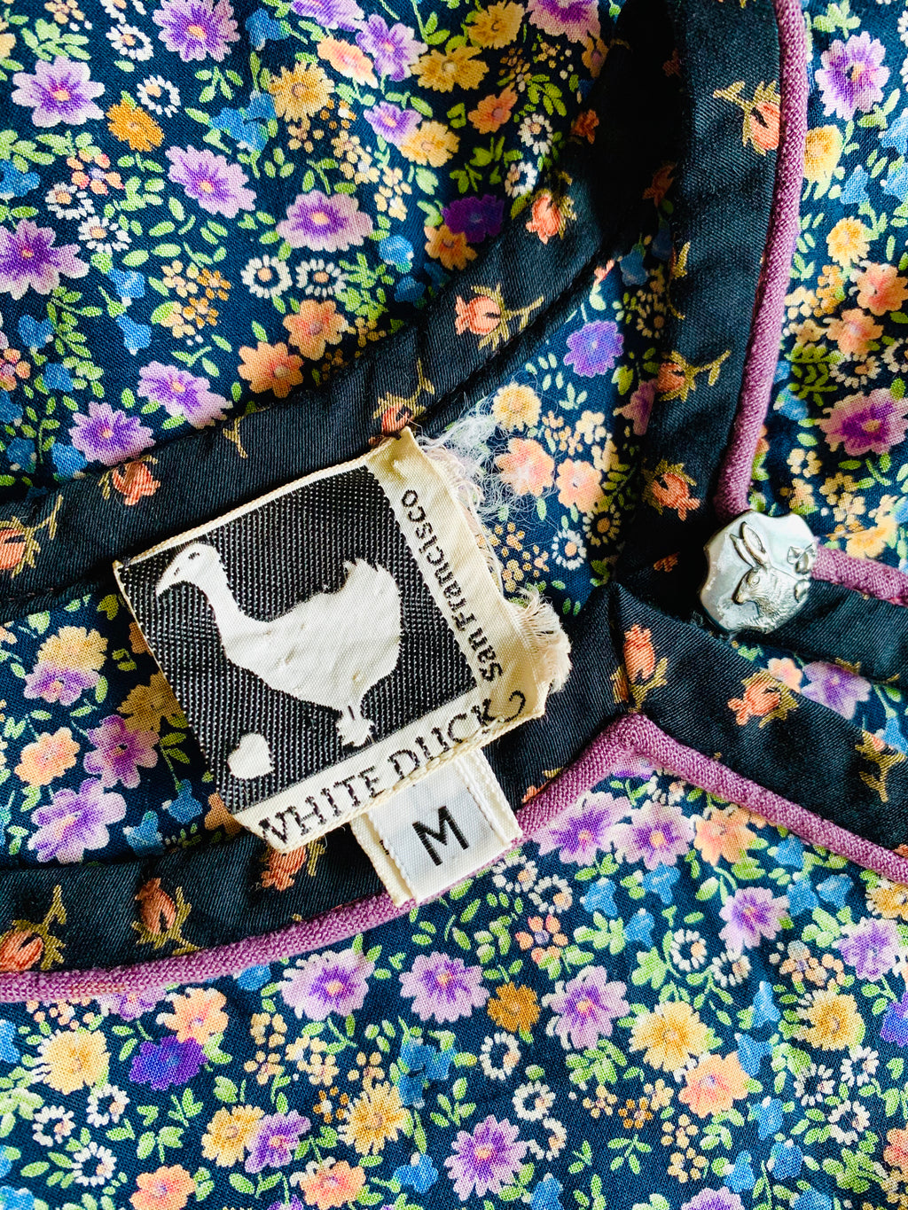 White Duck San Francisco vintage clothing label on a floral cotton dress.