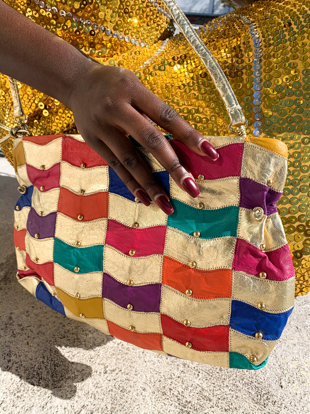 Find gold at the end of the rainbow with this gorgeous leather patchwork vintage purse.