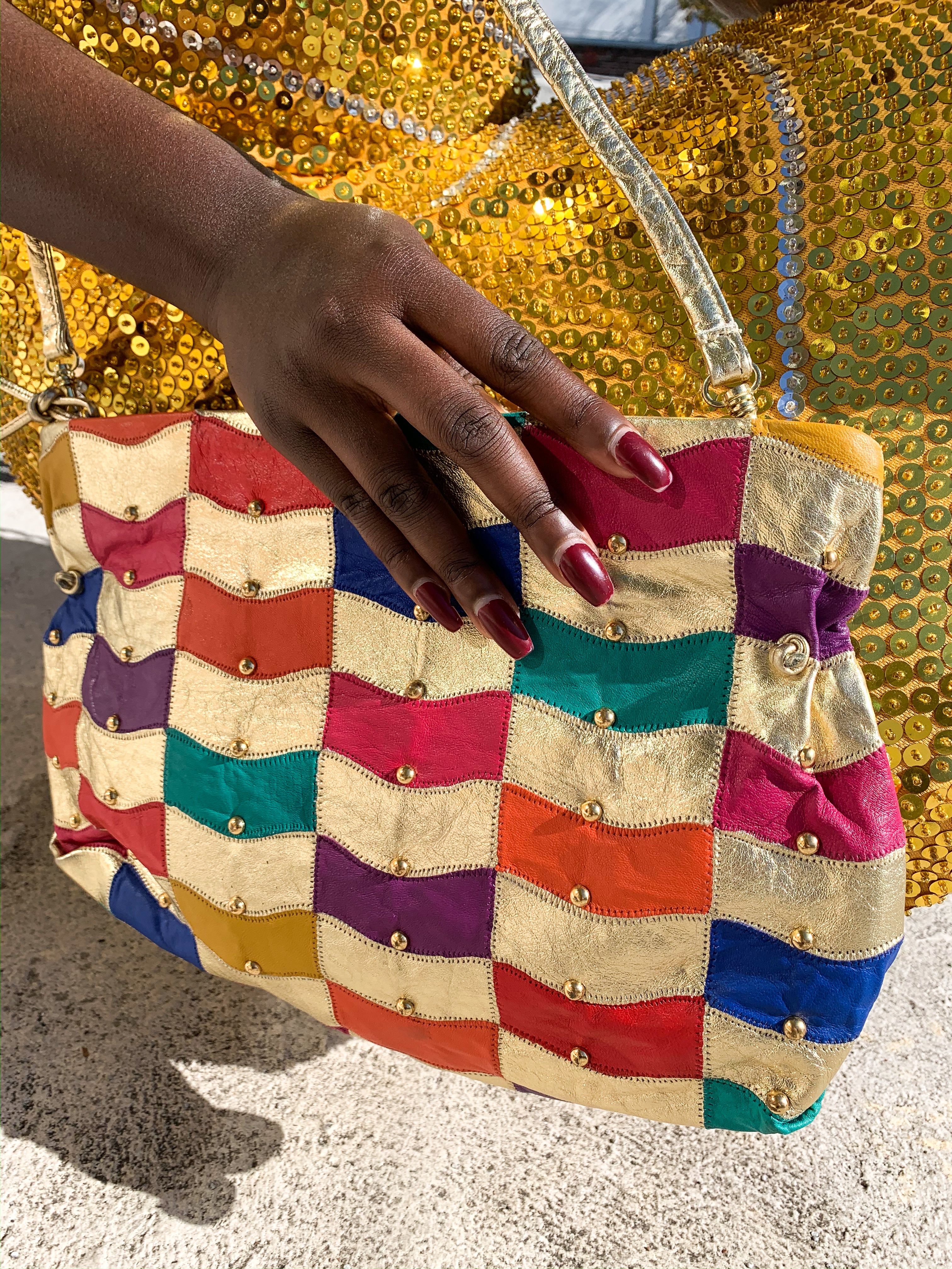Find gold at the end of the rainbow with this gorgeous leather patchwork vintage purse.